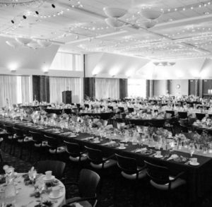 banquet setup for event with tables chairs and decorative lights