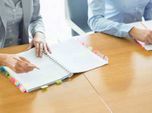person taking notes in notebook